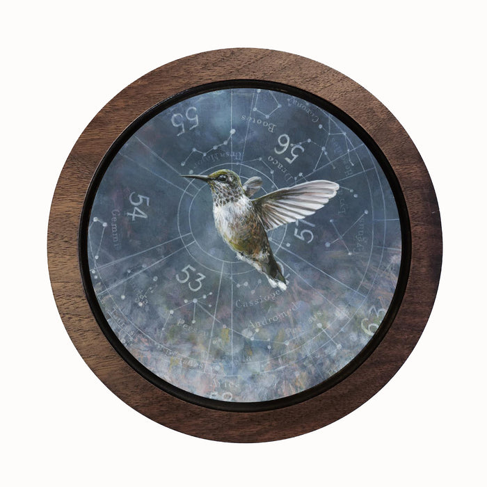 "Spring Hummingbird" by Christina Keith. A small round painting featuring a hummingbird and celestial map background.