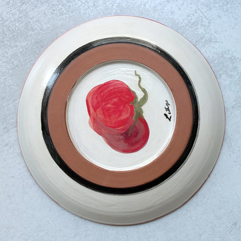 Handmade ceramic shallow serving bowl with tomato decoration by Molly Lithgo. Bottom view.