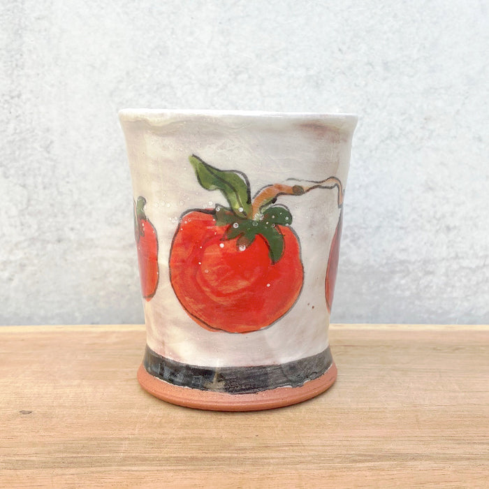 Handmade ceramic cup by NC potter Molly Lithgo. White with red tomatoes on the vine decoration. 