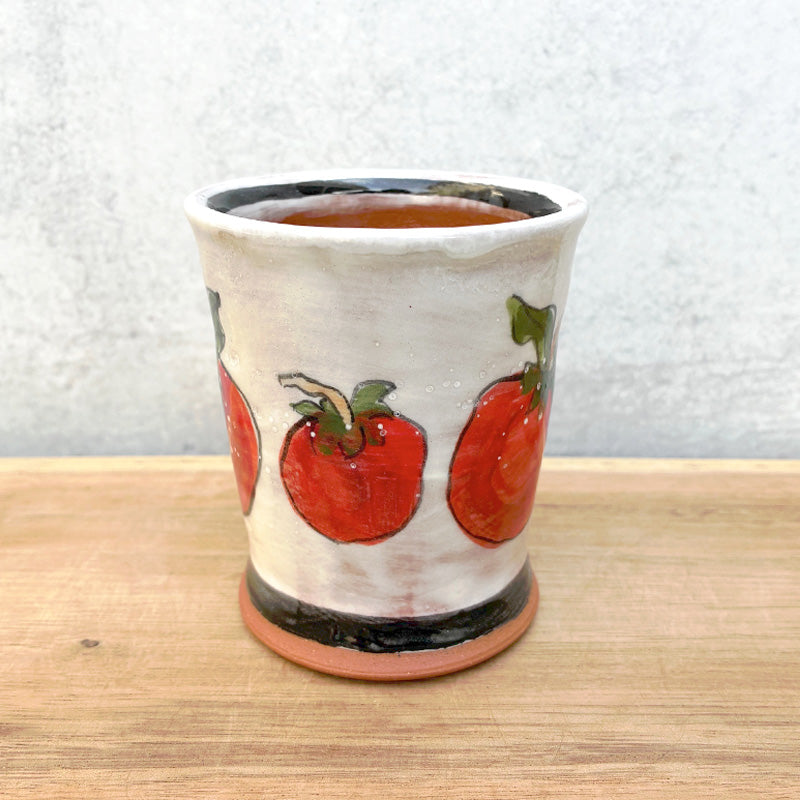 Handmade ceramic cup by NC potter Molly Lithgo. White with red tomatoes decoration. 