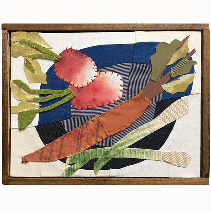 Veggie Plate textile collage by artist Hannah Goff. The artwork is comprised of hand-sewn and painted, reclaimed and recycled fabrics. It features a carrot, radishes and green onions on a blue plate. Finished in a handmade rustic wood frame.