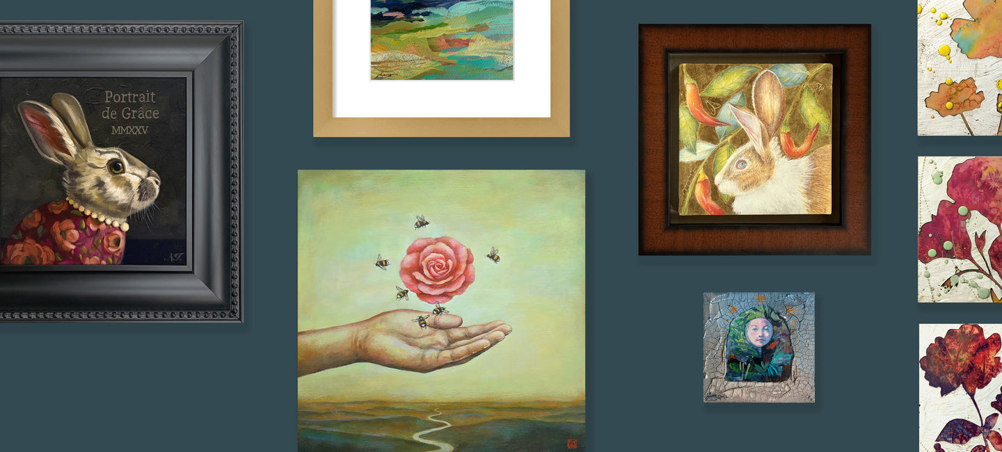 Various paintings from Lark & Key's Wish List group exhibition showcased on a dark blue wall. Two rabbit themed paintings, three flower themed paintings, a colorful landscape and small mixed media portal. 