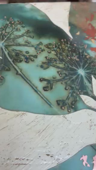 Video of Midnight Embers I mixed media encaustic leaf artwork in rich blues with gold and copper leaf details.